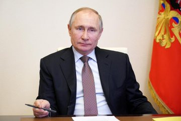 Vladimir Putin signs legislation that formally grants him the right to stay in power until 2036