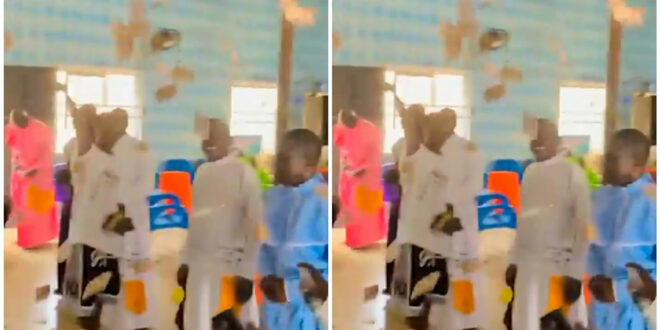 Young boys spray money lavishly in a church while being hailed by members (video)