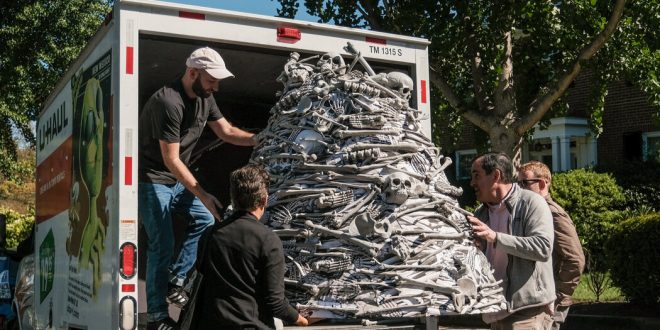 Activists take vaccine demands, and a mountain of fake bones, to the home of Biden’s chief of staff.