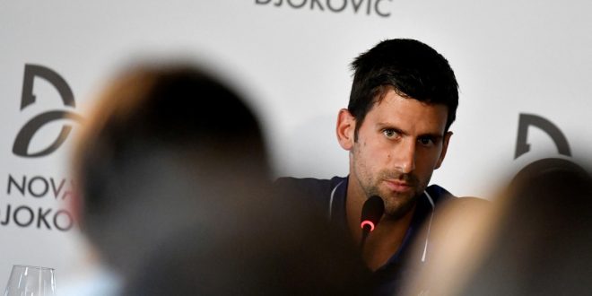 Djokovic lands in Australia but held up by visa issue