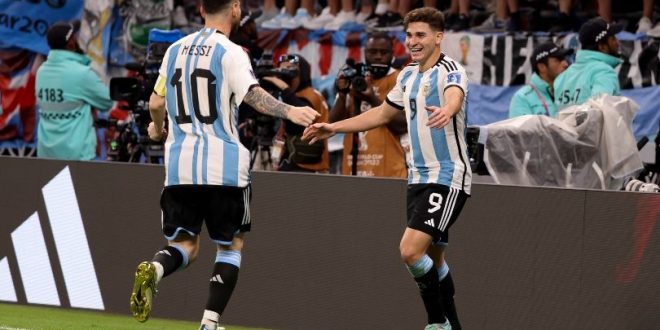 Lionel Messi celebrates with Julian Alvarez