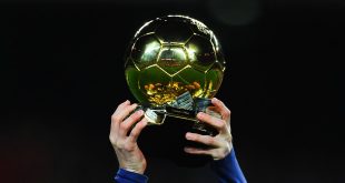 Lionel Messi of FC Barcelona holds up the FIFA Ballon d