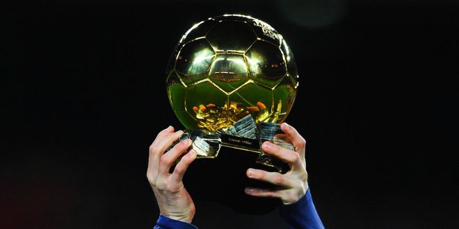 Lionel Messi of FC Barcelona holds up the FIFA Ballon d