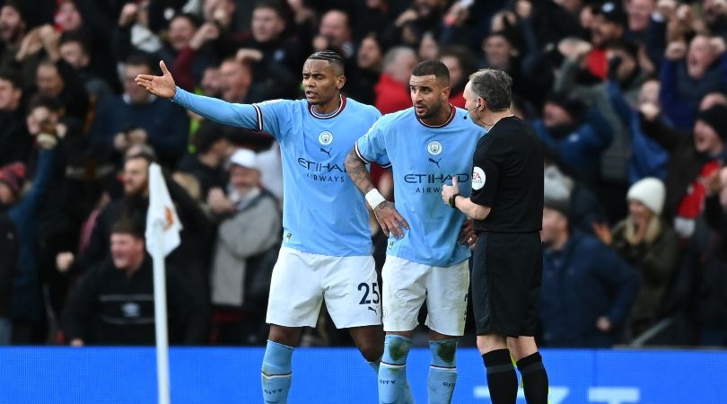 Manchester City players Riyad Mahrez and Manuel Akanji protest with the assistant referee after Manchester United