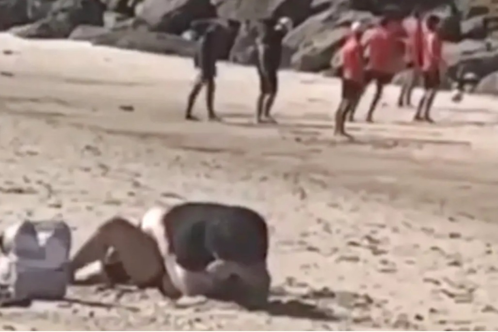 Couple confronted while having intercourse on packed public beach