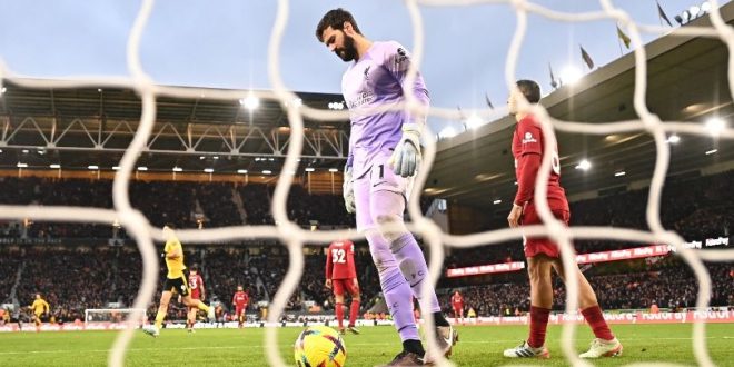 Liverpool goalkeeper Alisson Becker looks dejected after conceding in the Reds