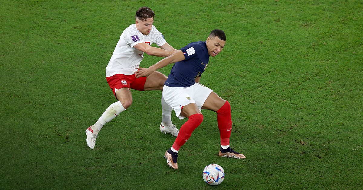 Kylian Mbappe #10 of France and Matty Cash #2 of Poland go after the ball during the FIFA World Cup Qatar 2022 Round of 16 match between France and Poland at Al Thumama Stadium on December 04, 2022 in Doha, Qatar.
