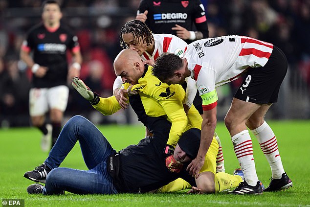 Update: Pitch invader who attacked Sevilla goalkeeper Marko Dmitrovic handed a 40-Year stadium ban and three-month prison sentence