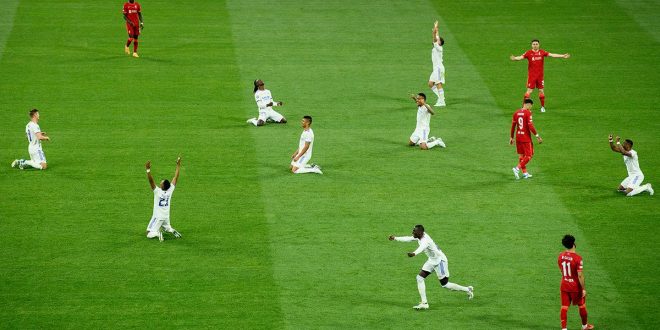 Players of Real Madrid celebrate as the final whistle is blown to confirm them as winners of the UEFA Champions League following victory in the UEFA Champions League final match between Liverpool FC and Real Madrid at Stade de France on May 28, 2022 in Paris, France.