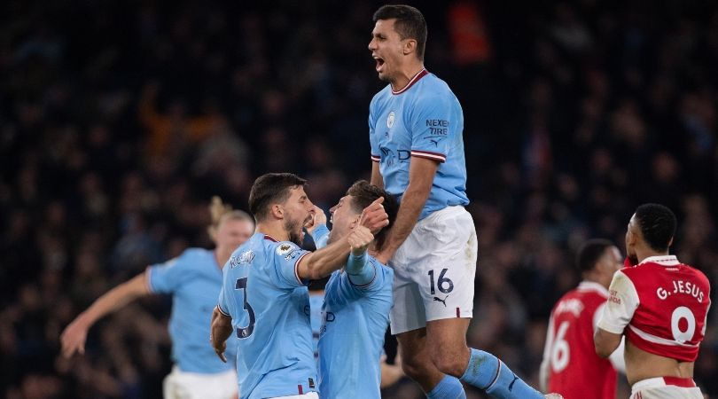 Manchester City players celebrate a goal against Arsenal in April 2023.