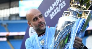 Manchester City manager Pep Guardiola holds aloft the Premier League trophy at the Etihad in May 2023.
