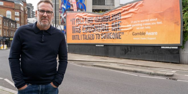 Paul Merson in front of a new GambleAware billboard
