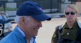 Biden laughs as he talks about Trump's mugshot.
