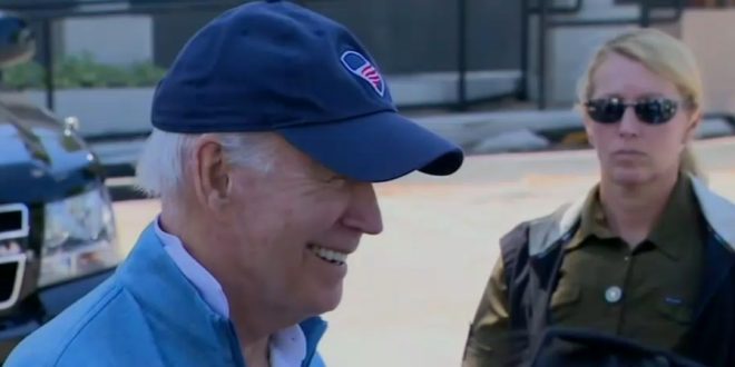 Biden laughs as he talks about Trump's mugshot.