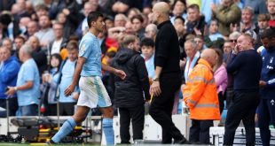 Rodri walks past Pep Guardiola following his red card in Manchester City