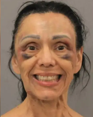 Wife grins in mugshot after allegedly shooting husband when he insisted on divorce