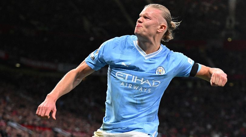 Manchester City striker Erling Haaland celebrates after scoring a penalty against Manchester United at Old Trafford.