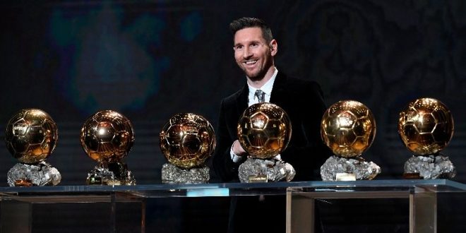 Lionel Messi poses with his Ballons d