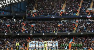 Manchester City and Brighton fans observe a minute