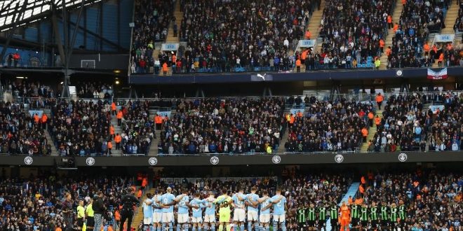 Manchester City and Brighton fans observe a minute
