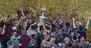 Fluminense players celebrate with the Copa Libertadores trophy after victory over Boca Juniors in November 2023.