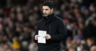 Arsenal manager Mikel Arteta holds a notepad during his side
