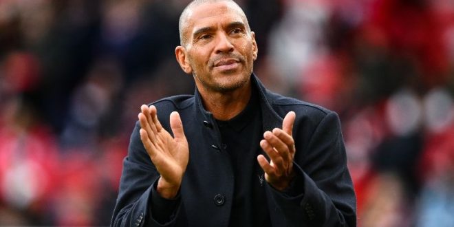 Stan Collymore applauds fans at the City Ground during Nottingham Forest