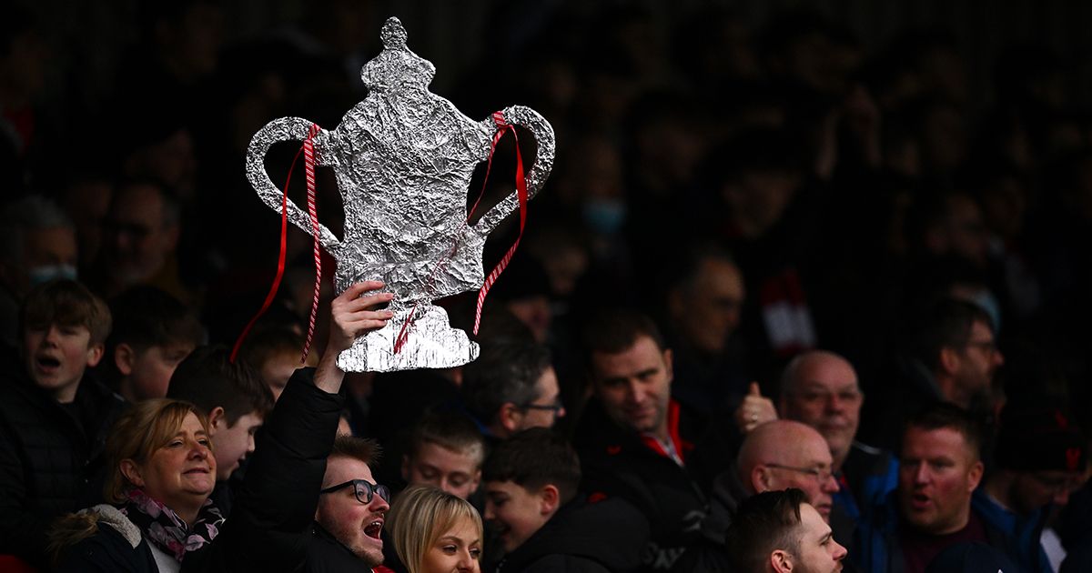 A fan of Kidderminster Harriers holds up a Tin foil FA Cup Trophy during the Emirates FA Cup Third Round match between Kidderminster Harriers and Reading at Aggborough Stadium on January 08, 2022 in Kidderminster, England.