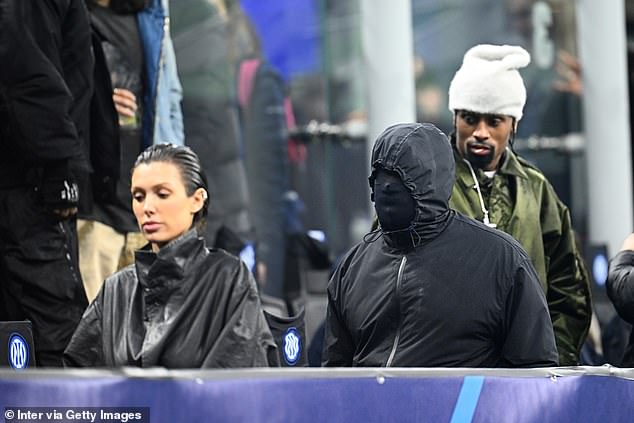 Kanye West wears a mask covering his entire face as he watches Inter Milan beat Atletico Madrid at the San Siro with wife Bianca and Ty Dolla $ign (Photos)