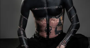 Machine Gun Kelly debuts dramatic upper torso blackout tattoo