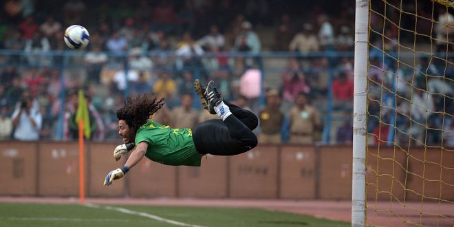 Former Colombian goolkeeper Rene Higuita kicks the ball to save a goal during an exhibition match between the Brazilian Masters and Indian All Stars in Kolkata on December 8, 2012. The Brazilian team won the match by 3-1. AFP PHOTO/ Dibyangshu SARKAR (Photo credit should read DIBYANGSHU SARKAR/AFP via Getty Images)