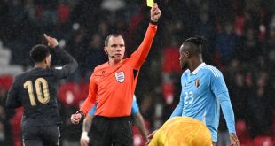 Michy Batshuayi of Belgium receives a yellow card from referee Sebastian Gishamer during a friendly football game between the national teams of England and Belgium in preparation on the UEFA Euro 2024 tournament, on March 26, 2024 in Wembley Stadium, London, England, United Kingdom. (Photo by Isosport/MB Media/Getty Images)