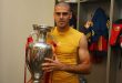 Víctor Valdés poses with the Euro 2012 trophy after Spain