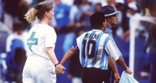 Diego Maradona holds hands with a nurse as he is led away for a drugs test following Argentina