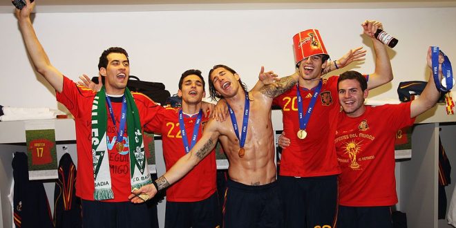 Sergio Busquets, Jesus Navas, Sergio Ramos, Javier Martinez and Juan Manuel Mata of Spain pose with the trophy in the Spanish dressing room after they won the 2010 FIFA World Cup at Soccer City Stadium on July 11, 2010 in Johannesburg, South Africa