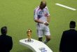 Zinedine Zidane walks past the World Cup trophy following his red card in France