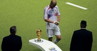 Zinedine Zidane walks past the World Cup trophy following his red card in France