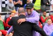 Liverpool manager Jurgen Klopp embraces Spurs boss Ange Postecoglou.
