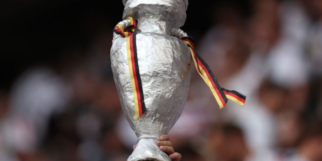 Euro 2024 injuries: A fan holds a tinfoil replica of the UEFA EURO 2024 Trophy, seen prior to the UEFA EURO 2024 group stage match between Germany and Scotland at Munich Football Arena on June 14, 2024 in Munich, Germany.