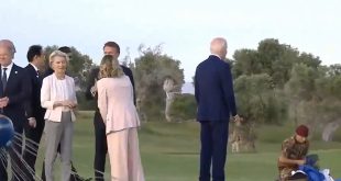 Biden at the G-7 talks to a parachute jumper.