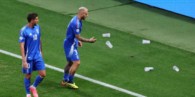 Federico Dimarco of Italy throws plastic beer cups off of the pitch during the UEFA EURO 2024 group stage match between Croatia and Italy at Football Stadium Leipzig on June 24, 2024 in Leipzig, Germany.
