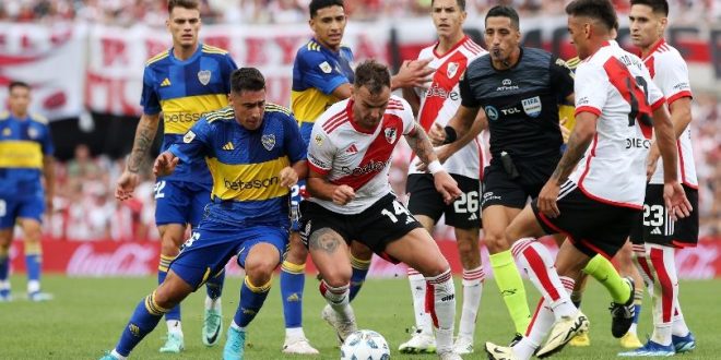 Boca juniors and River Plate players battle for the ball in a match at the Estadio Monumental in February 2024.