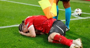 Marcel Sabitzer lies on the floor after being struck by an object during Turkey