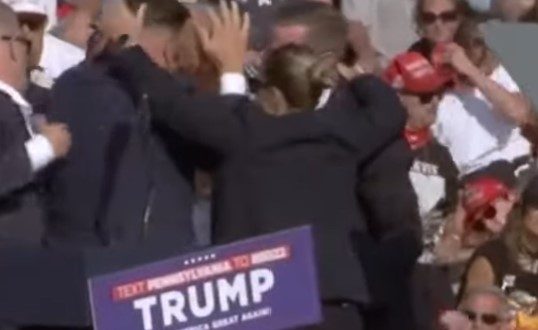 Secret Service rushes to Trump after rally shooting.