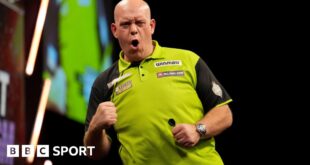 Michael van Gerwen holds up his fist in celebration