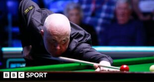 Four-time world snooker champion John Higgins in action