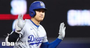 Shohei Ohtani of the Los Angeles Dodgers reacts after hitting a double against the Miami Marlins