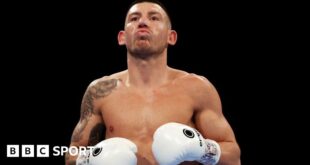 Liam Williams with white gloves in the ring