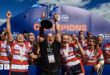 Sean Lynn (centre) holds the Premiership Women's Rugby trophy in the air surrounded by players after the club won the final last season