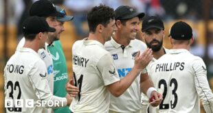 Matt Henry and Tim Southee of New Zealand celebrate a wicket against India